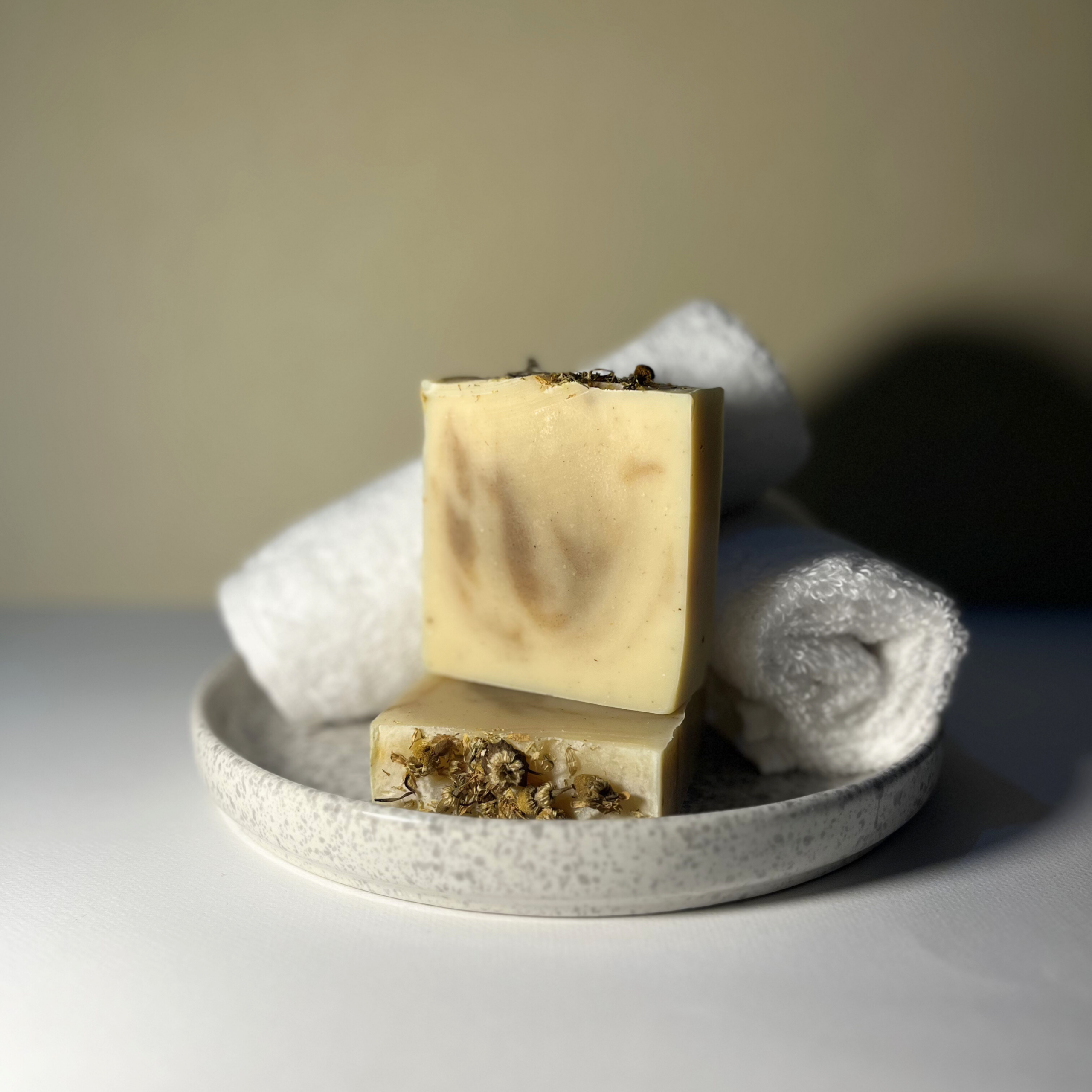 Handmade lemongrass soap with lemon essential oil, moringa powder, chamomile flowers and natural swirl design