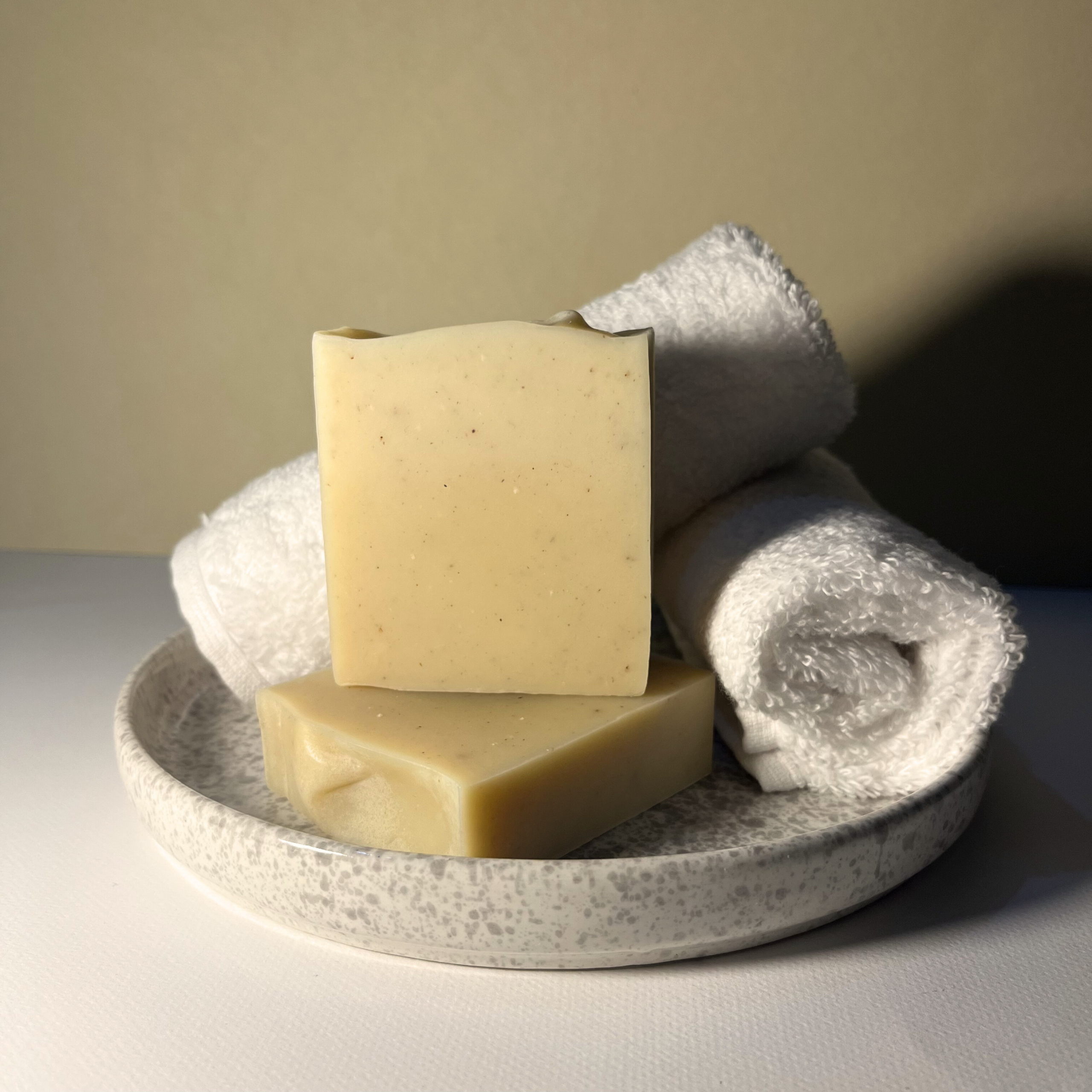 Handmade turmeric soap with orange peel powder in plain bar design