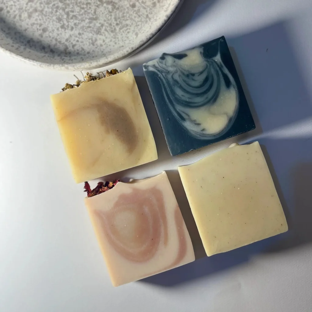 Four handmade soaps: lemongrass, activated charcoal, rose and turmeric
